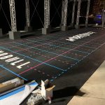 Outdoor competition grid with floor decals and Nobull branding at night.