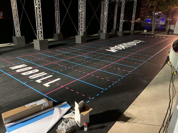 Outdoor competition grid with floor decals and Nobull branding at night.
