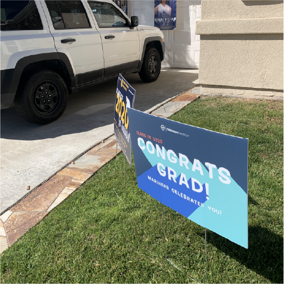 Custom coroplast yard sign on a grassy lawn with metal stake