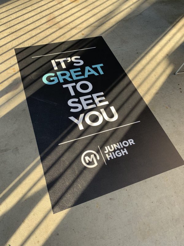 Rectangular vinyl floor decal greeting guests with “It’s Great to See You” message.
