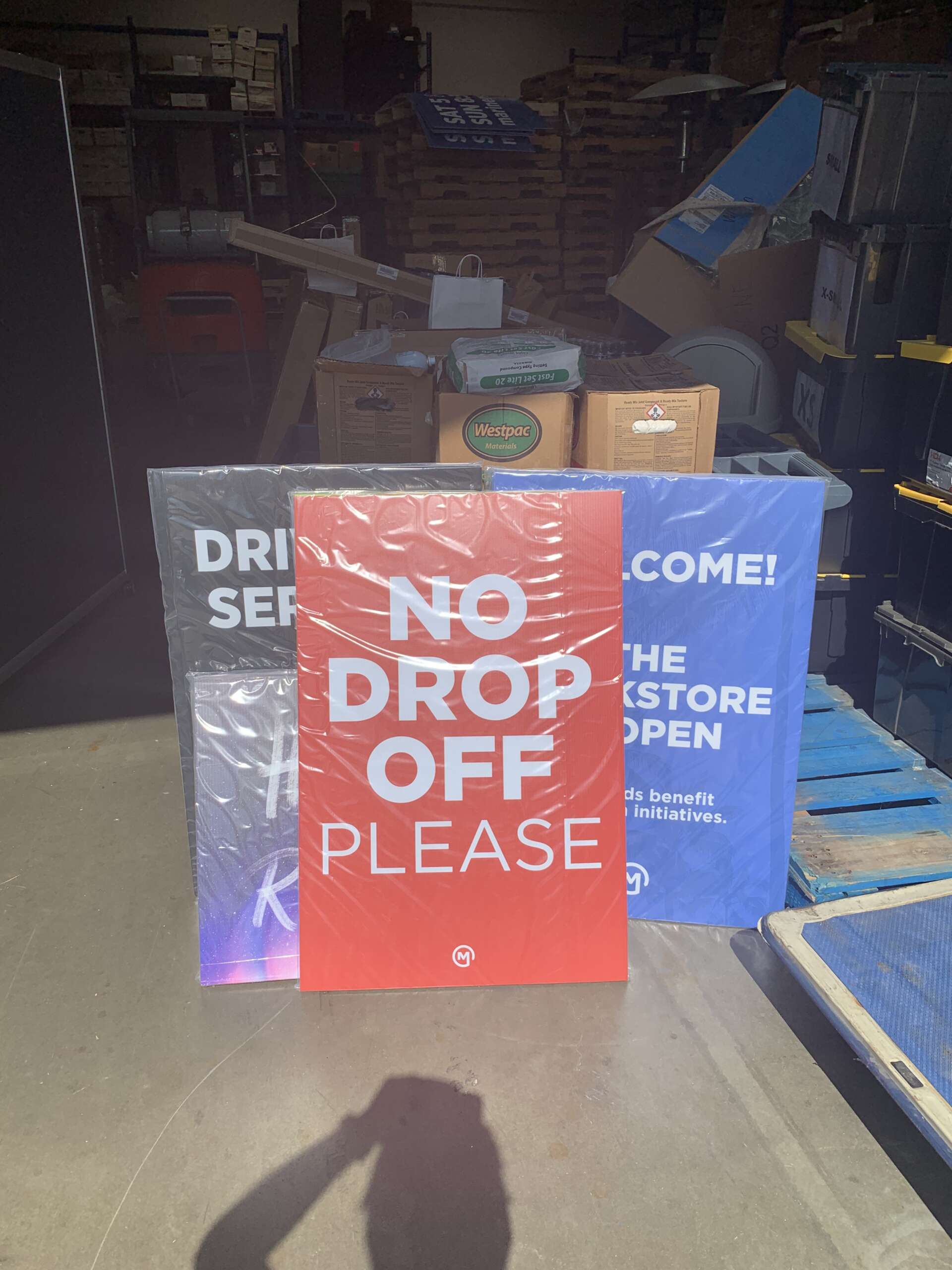 Stacked coroplast signs with bold red “No Drop Off Please” message