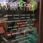 Custom vinyl window decal with business hours and logo for wellness clinic