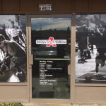 Custom CrossFit window decals with gym hours and athlete action photos