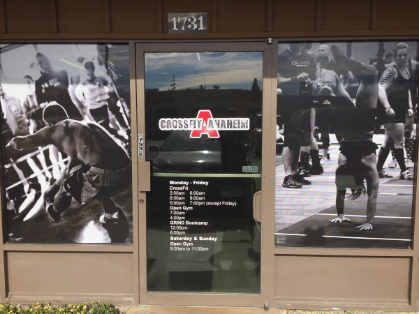 Custom CrossFit window decals with gym hours and athlete action photos