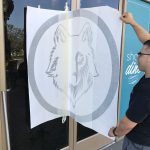 Custom window decal application for gym or business branding
