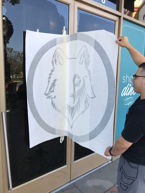 Custom window decal application for gym or business branding