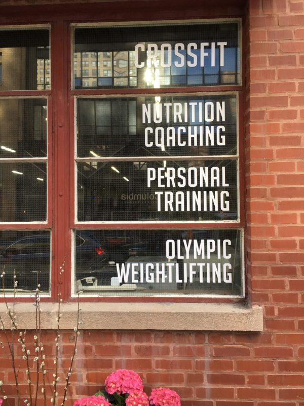 Gym window lettering listing CrossFit, coaching, and personal training