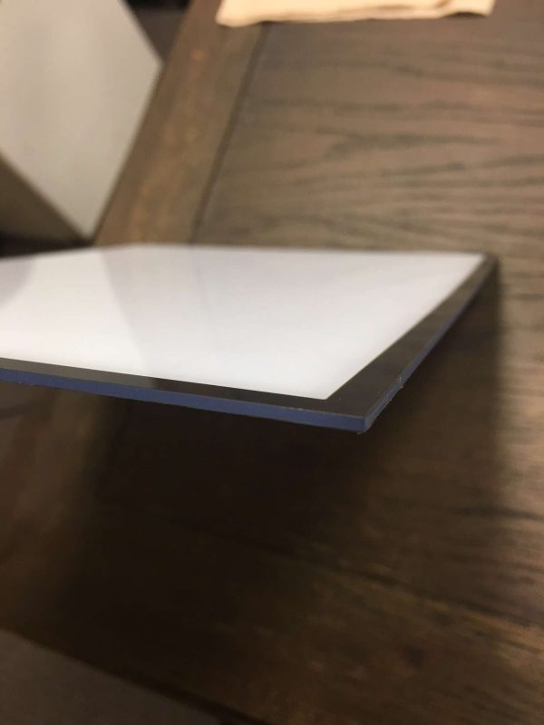 Close-up of acrylic signage panel with polished edge and smooth finish