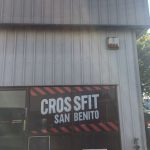 CrossFit San Benito logo on large front window with red and black striped border.