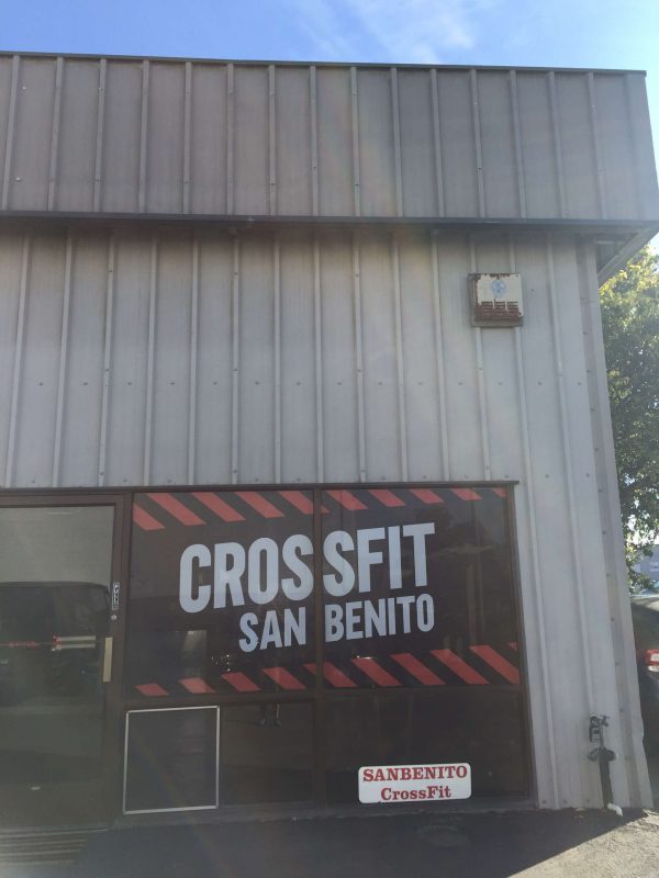 CrossFit San Benito logo on large front window with red and black striped border.