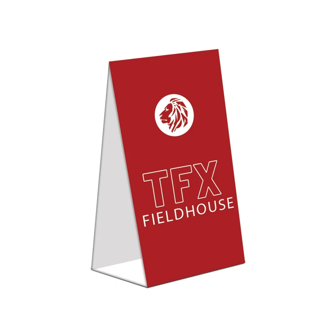 Red folded A-frame sign with white lion logo and “TFX Fieldhouse” in bold text.