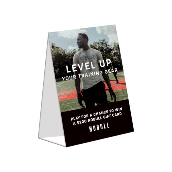Folded A-frame sign with NOBULL athlete and gift card promo message on sports field.