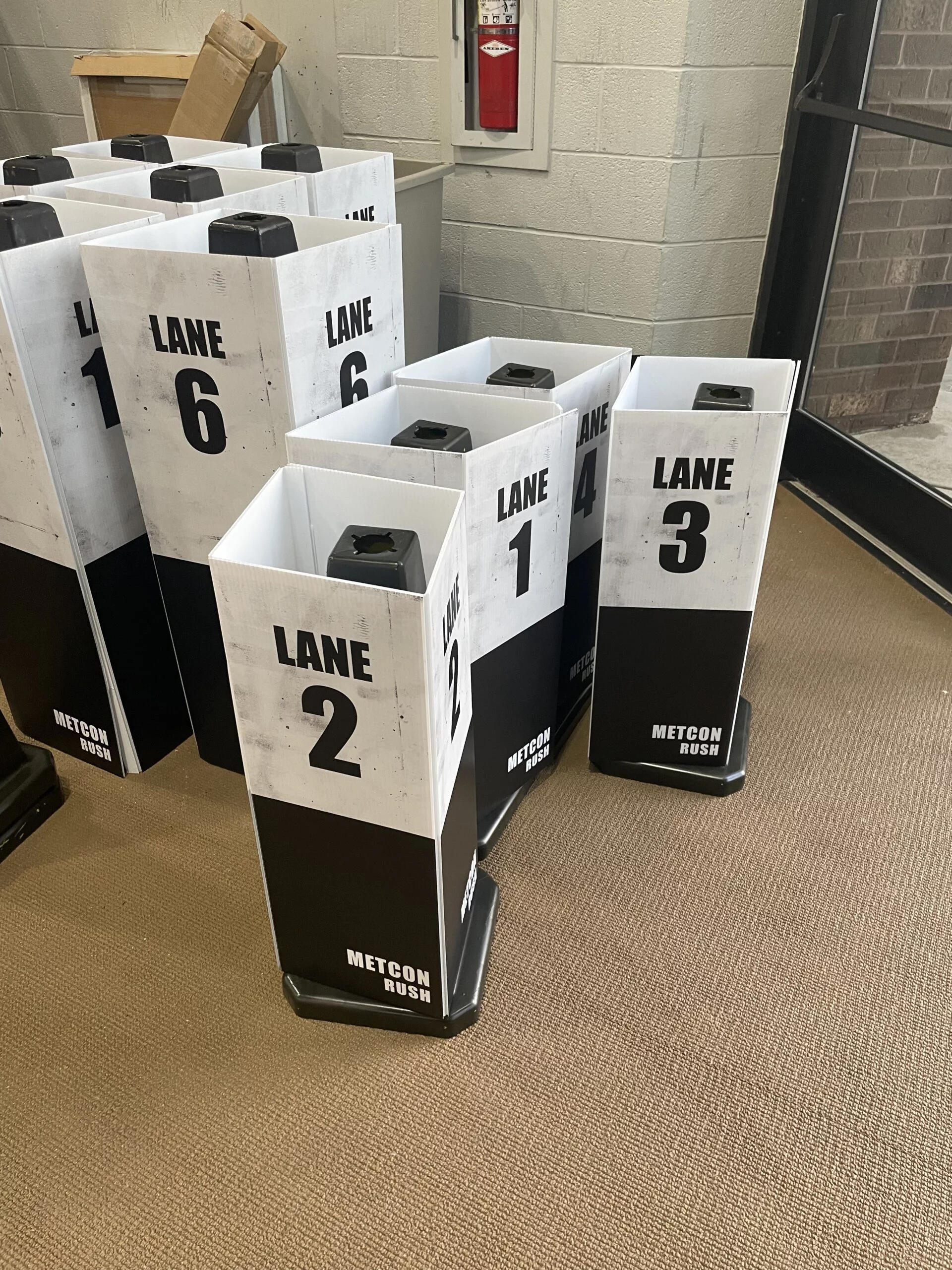 delineator-covers-2 Numbered delineator covers labeled for competition lanes at a fitness event.