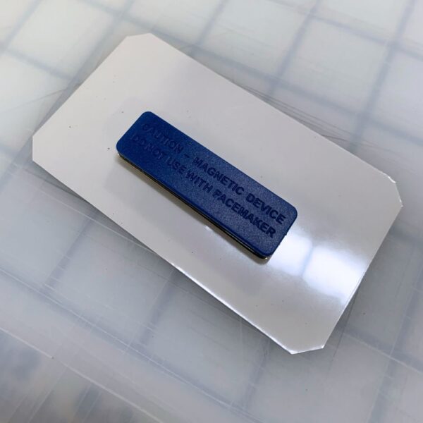 Back view of a magnetic name tag displaying the strong magnet attachment. Designed for secure, pin-free fastening, perfect for professional and event use.
