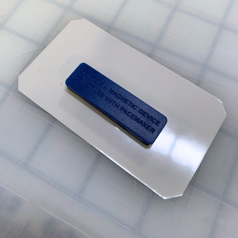 Back view of a magnetic name tag displaying the strong magnet attachment. Designed for secure, pin-free fastening, perfect for professional and event use.