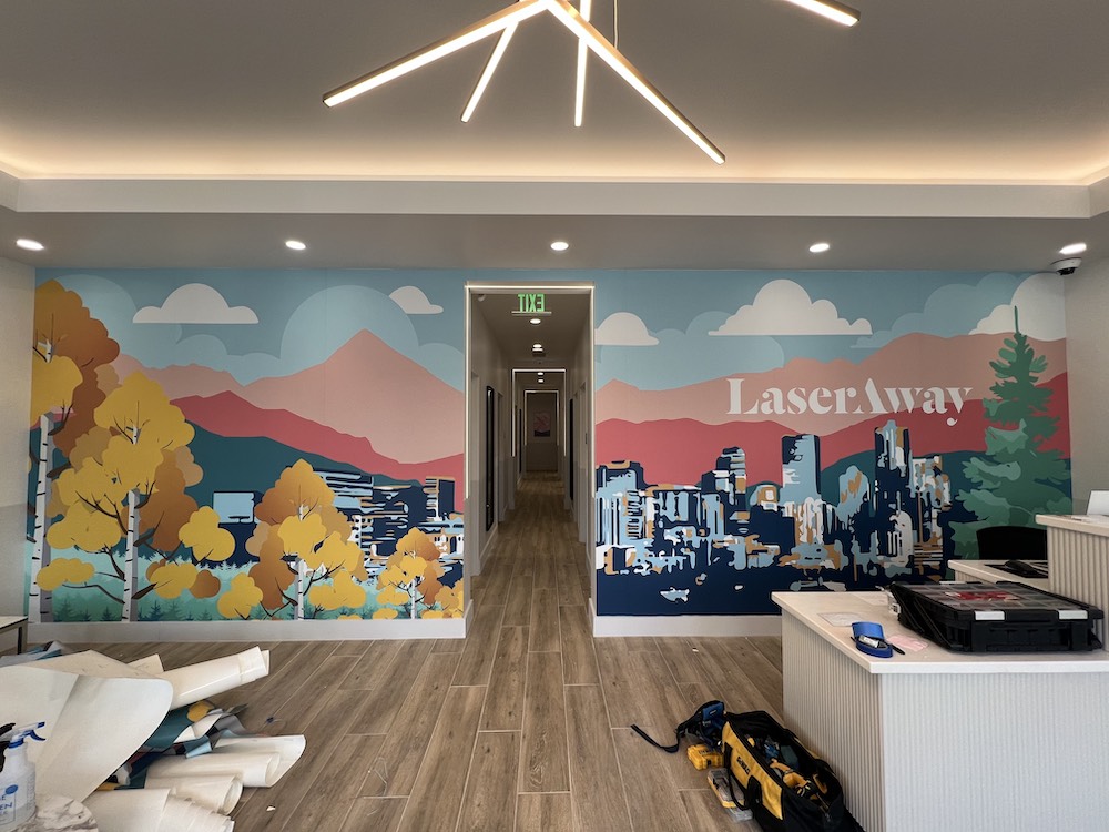 A modern mural with abstract patterns and shapes, using a mix of bold and neutral colors to create a dynamic visual effect.