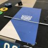 Full-scale gym event photo showing signage on wall and flooring