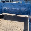 Barricade banner displaying logos and safety messages