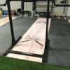 Rotated view of event signage featuring gym wall branding and podium